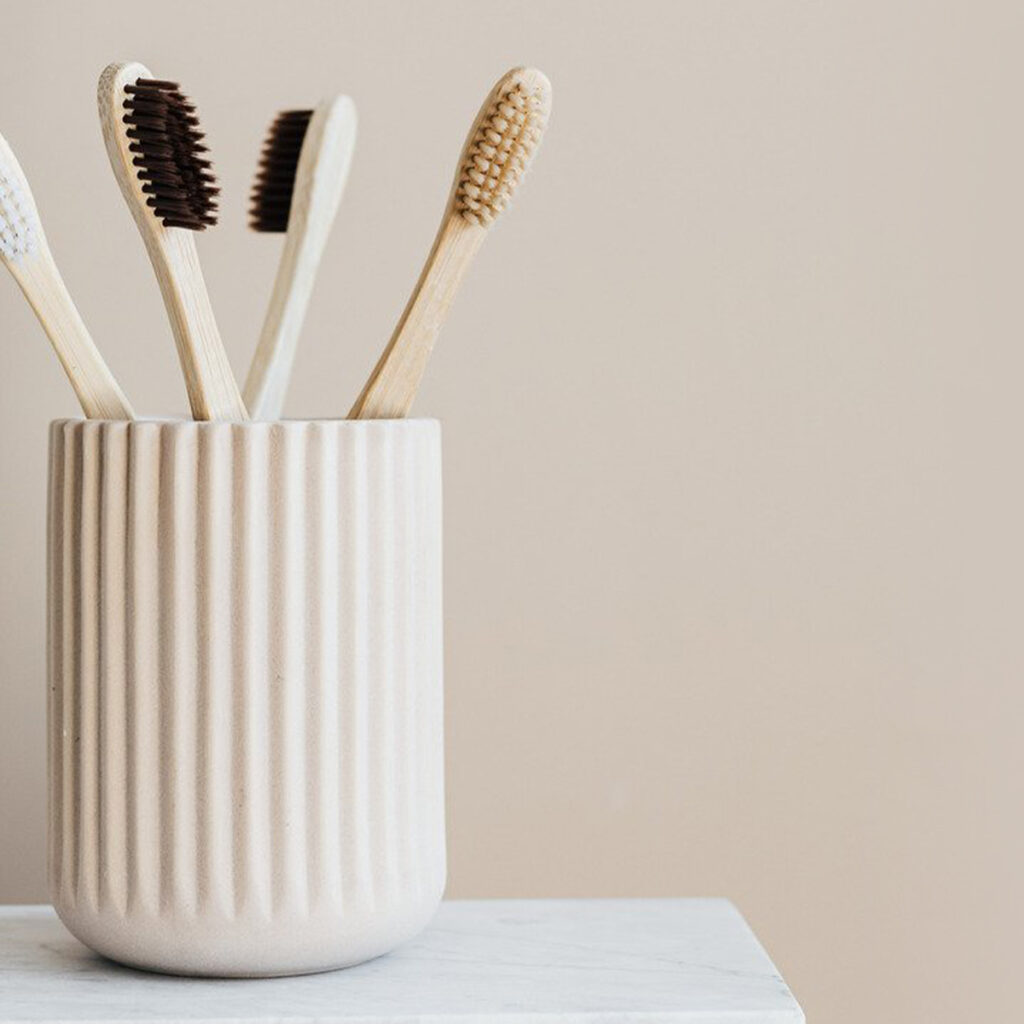 canva-set-of-natural-wooden-toothbrushes-in-white-holder-mad-xhjj1_q-crop-1